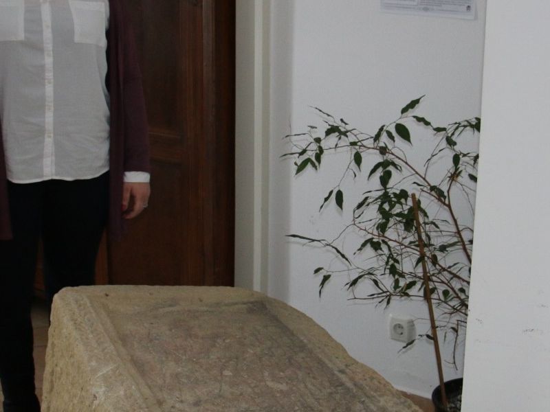 Tea Lokner uz jedan od artefakata iz MGP (rimski nadgrobni spomenik pronađen u selu Kusonje 1989. godine)